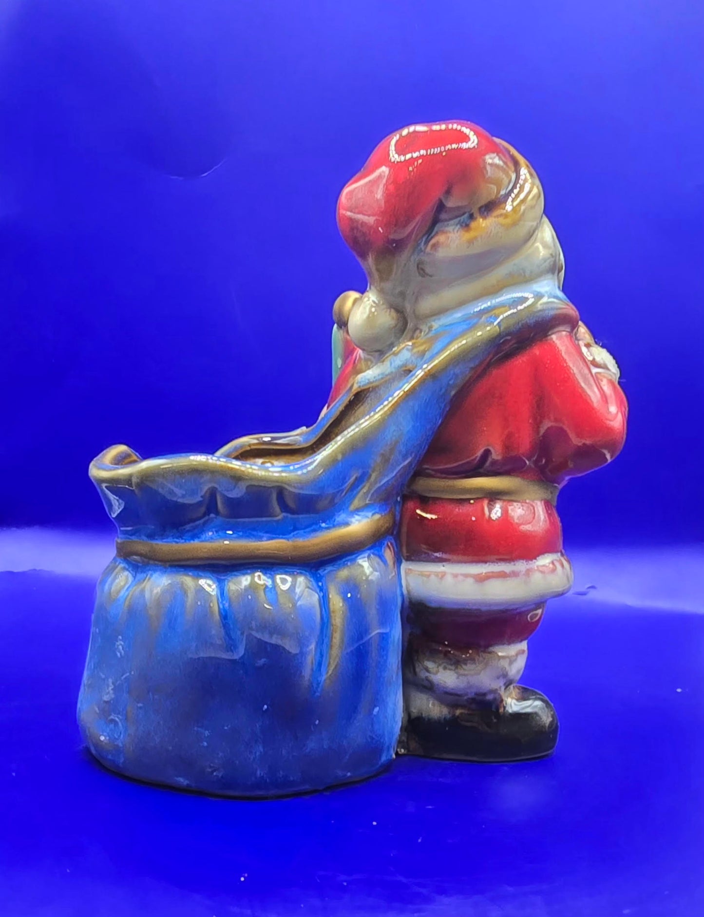 Ceramic Santa with empty bag It is 5.5 inches tall and 4 inches across.