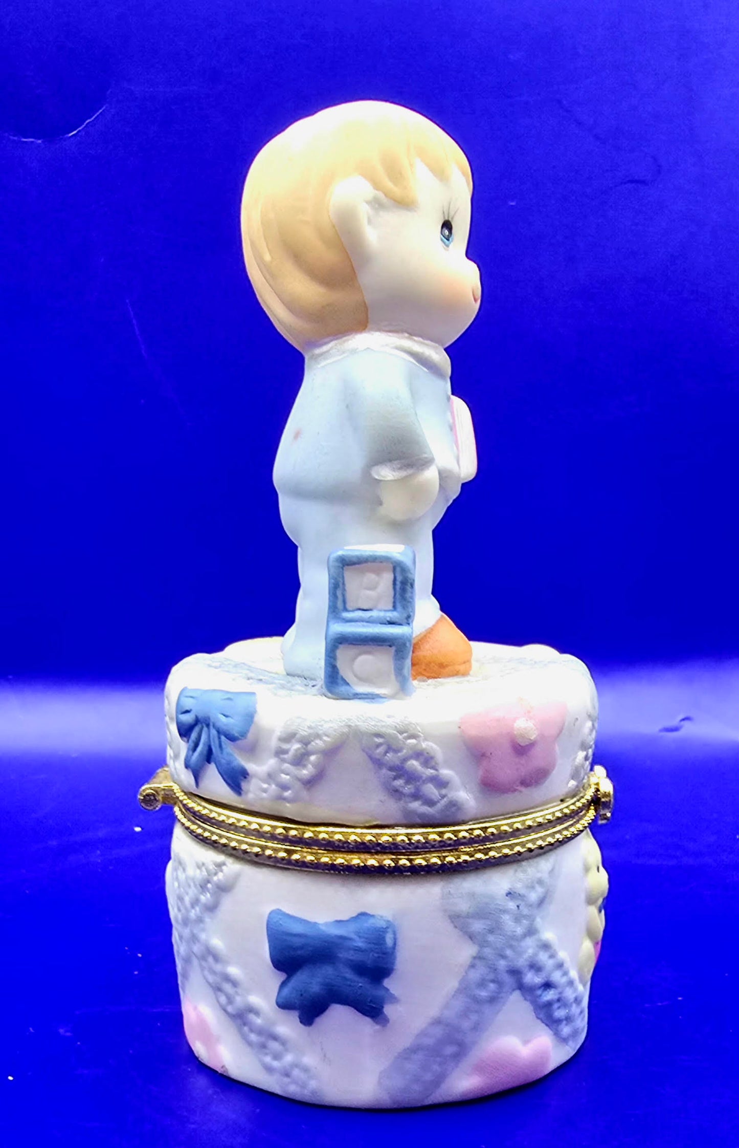 Little boy with building blocks and books a trinket box.