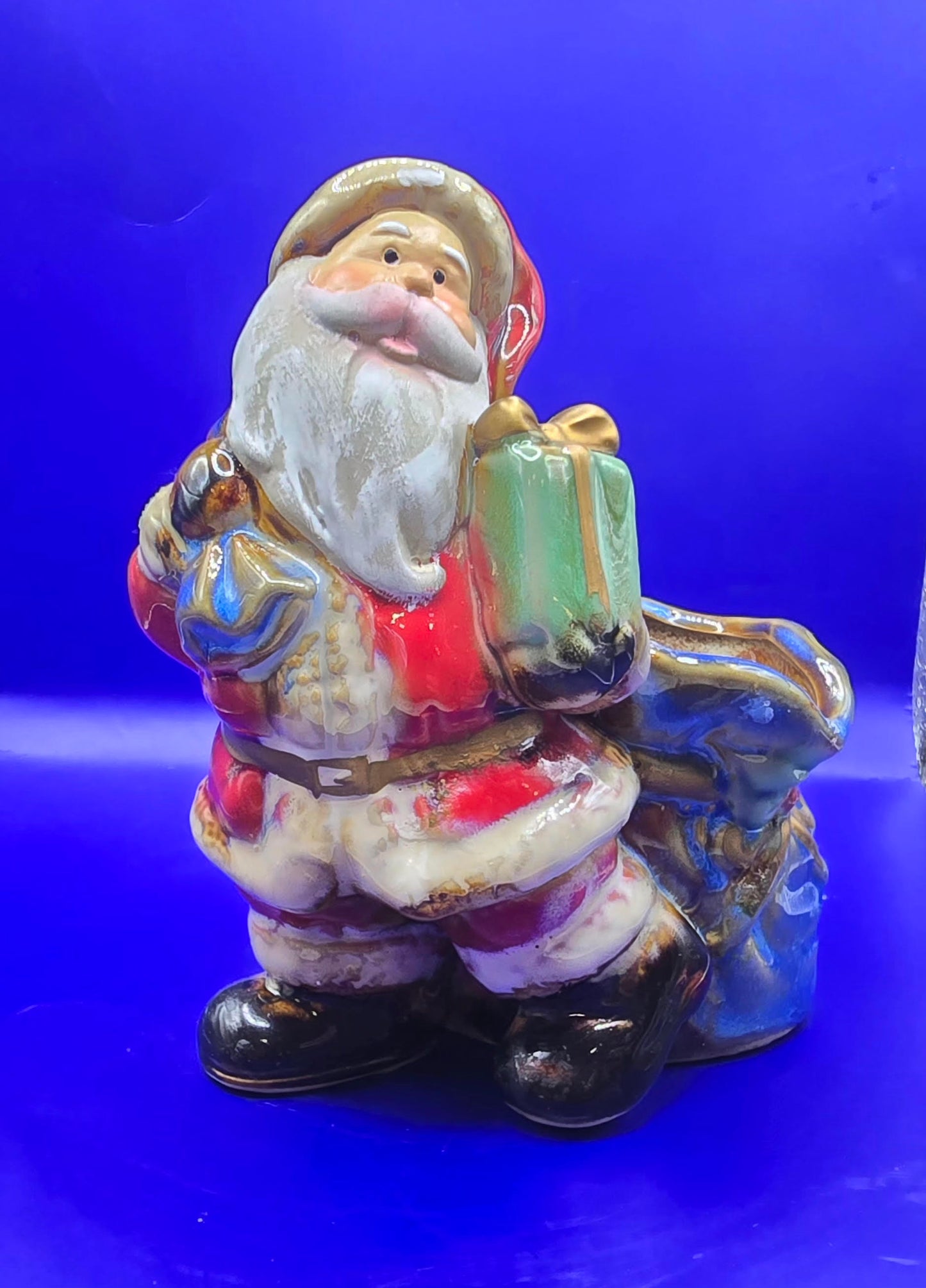 Ceramic Santa with empty bag It is 5.5 inches tall and 4 inches across.