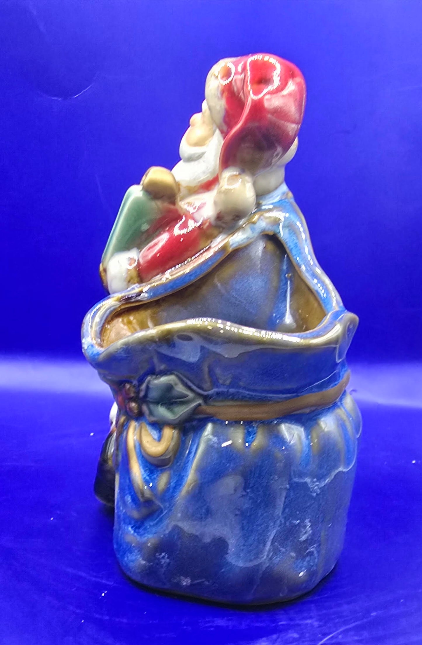 Ceramic Santa with empty bag It is 5.5 inches tall and 4 inches across.