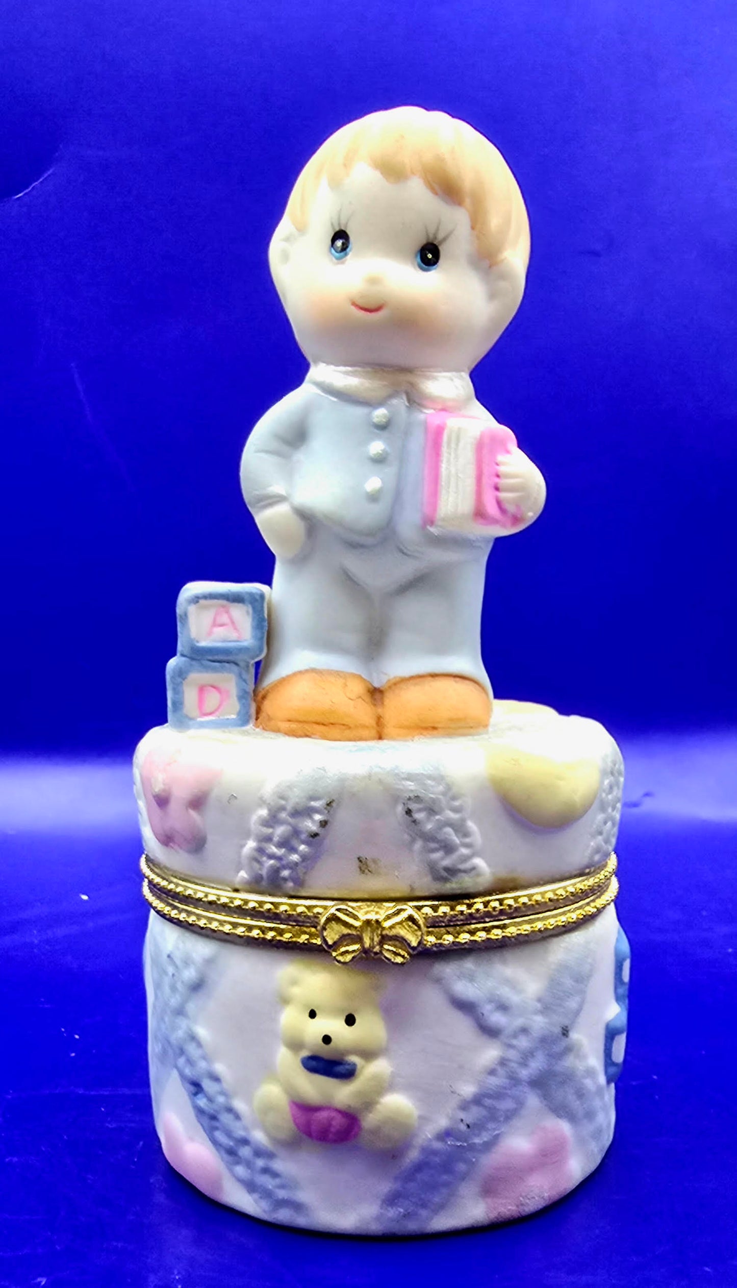 Little boy with building blocks and books a trinket box.